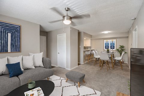 a living room and dining room with a couch and coffee table